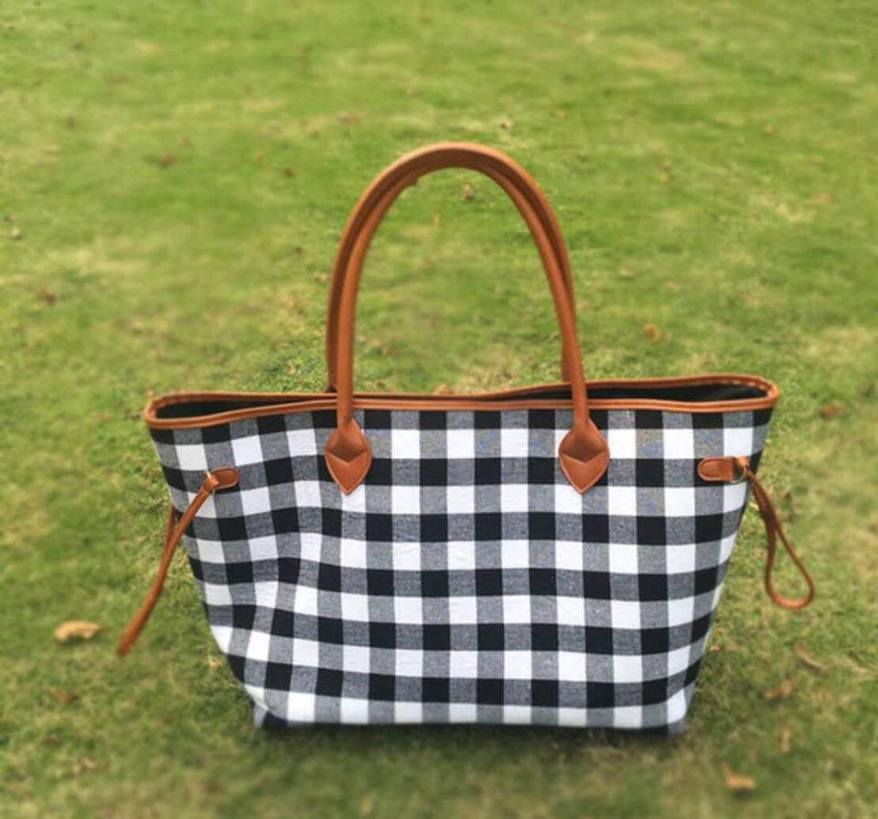large black and white buffalo check plaid bag with brown straps. perfect for anytime of the year and super eye catching