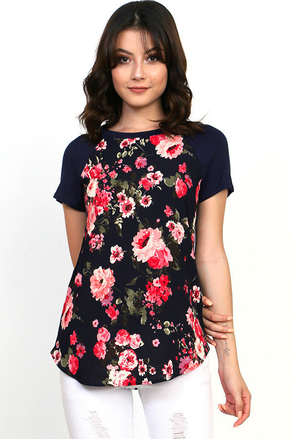 floral short sleeve top with black background contrast with rounded neck and bottom