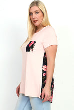blush and floral print short sleeve tunic top. round neck with a floral print front pocket and back