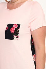 zoomed in view of pocket detail on the blush and floral print short sleeve tunic top. round neck with a floral print front pocket and back