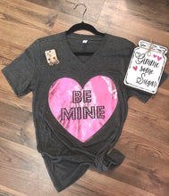 short sleeve charcoal grey gray tee with large pink foil heart in middle with be mine in large print within pink foil heart. womens fit with V neck. perfect lounging shirt or to tie the bottom and pair with jeans and booties