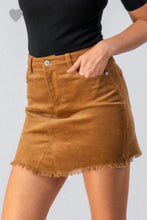 camel colored corduroy mini skirt with a zipper fly. equipped with belt loops and pockets. frayed hem on the bottom