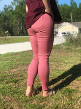 back view of raspberry moto jeggings with real back pockets and an elastic waistband. can be worn everyday casual or with a dressy top and heels. S/M fit- 2-6. M/L fit- 8-10