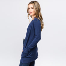 side view of Navy blue colored soft and cozy cardigan with pockets. long sleeve and in between knee and butt length