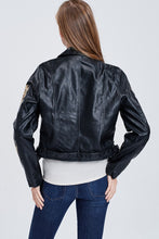 back view of faux leather jacket with embroidered sleeves. meets at your waist. zip up in front and tie around waist