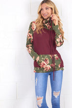 burgundy and olive floral sweater top. Long sleeve with olive floral contrast from burgundy flows to neck line and front pouch