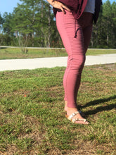 side view of raspberry moto jeggings with real back pockets and an elastic waistband. can be worn everyday casual or with a dressy top and heels. S/M fit- 2-6. M/L fit- 8-10