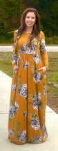 mustard and floral print long sleeve long maxi dress. soft and stretchy material. cinched at the waist with pockets 