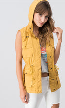 mustard sleeveless collared cargo vest with 4 front pockets, draw string at waist, and hood