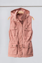 blush sleeveless collared cargo vest with 4 front pockets, draw string at waist, and hood