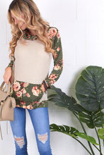 cream and olive floral sweater top. Long sleeve with olive floral contrast from burgundy flows to draw string gathered neck line and front pouch
