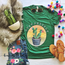 flatlay of green unisex fit tee with cactus print and stay prickly in front center