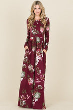 long sleeve burgundy and floral long mazi dress. super soft and stretchy material cinched at the small of your waist. beautiful eye catching burgundy color. and has pockets 