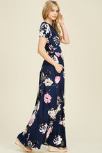 side view of Navy and floral print short sleeve long maxi with soft and stretchy material, scoopneck, and pockets