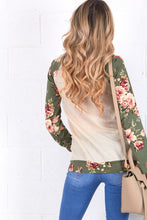 back view of cream and olive floral sweater top. Long sleeve with olive floral contrast from burgundy flows to draw string gathered neck line and front pouch