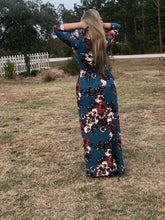back view of Navy and floral print 3/4 long sleeve long maxi dress with stretchy, soft, and comfortable material with pockets. perfect for any occasion and so many seasons