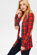 side view of red plaid open face cardigan with long sleeves and faux suede light brown elbow patches. passed the butt in length