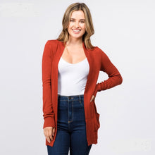 rust colored soft and cozy cardigan with pockets. long sleeve and in between knee and butt length
