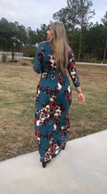 walking back view of Navy and floral print 3/4 long sleeve long maxi dress with stretchy, soft, and comfortable material with pockets. perfect for any occasion and so many seasons