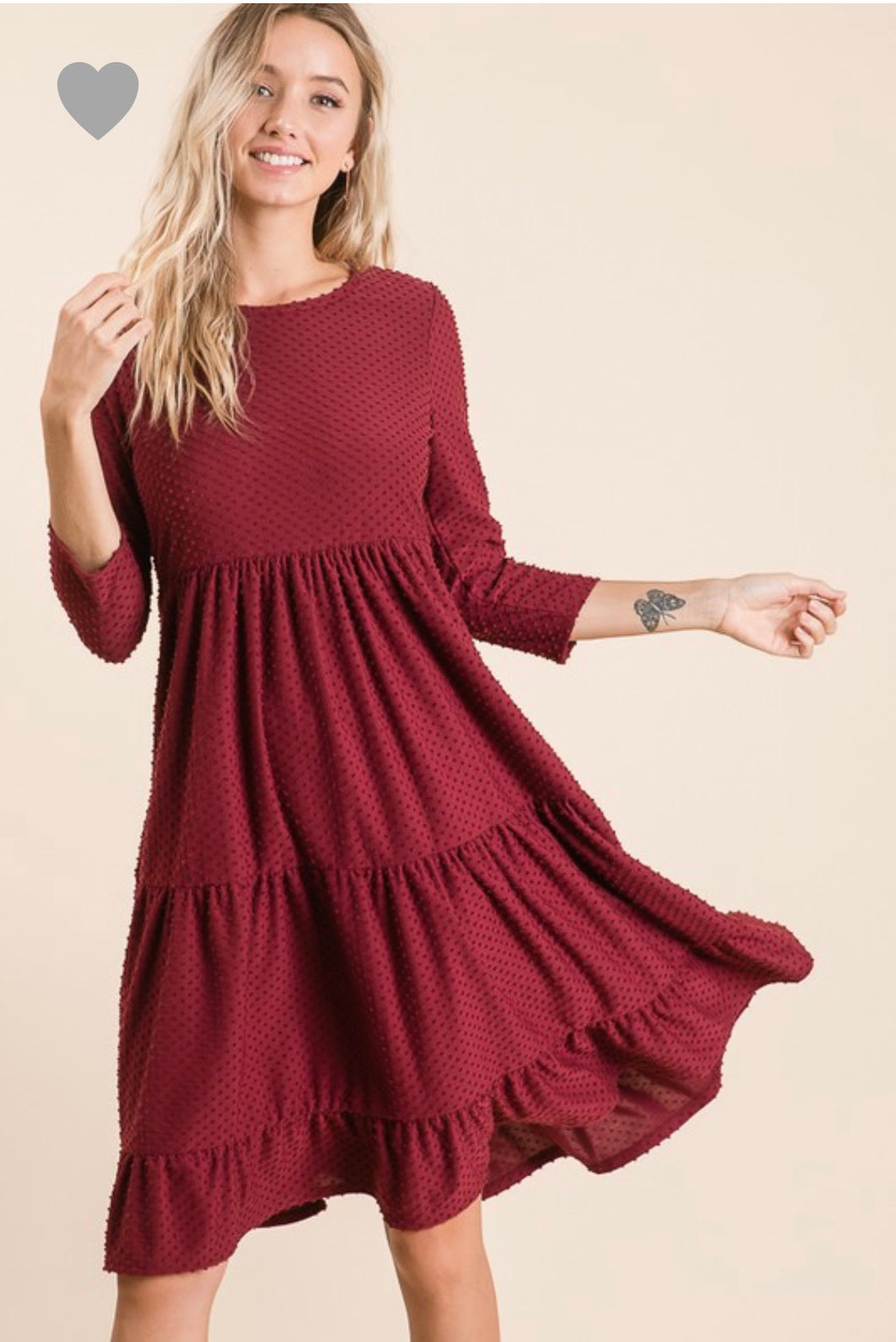 short sleeve burgundy with dot textured short dress that goes to knees. cinches at the small of the waist and flows out tiered on the bottom half