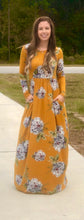 mustard and floral print long sleeve long maxi dress. soft and stretchy material. cinched at the waist with pockets 