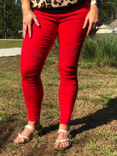 vibrant bright red moto jeggings with real back pockets and an elastic waistband. can be worn everyday casual or with a dressy top and heels. S/M fit- 2-6. M/L fit- 8-10