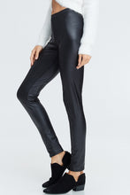 side view of faux leather leggings with an elastic waistband. perfect for any casual outfit or dressed up for a night out on the town