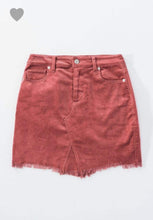 blush pink colored corduroy mini skirt with a zipper fly. equipped with belt loops and pockets. frayed hem on the bottom