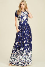 Navy ombre floral short sleeve long maxi dress with white floreal print heavy on top and bottom and faded in middle like falling flowers. scoopneck and pockets