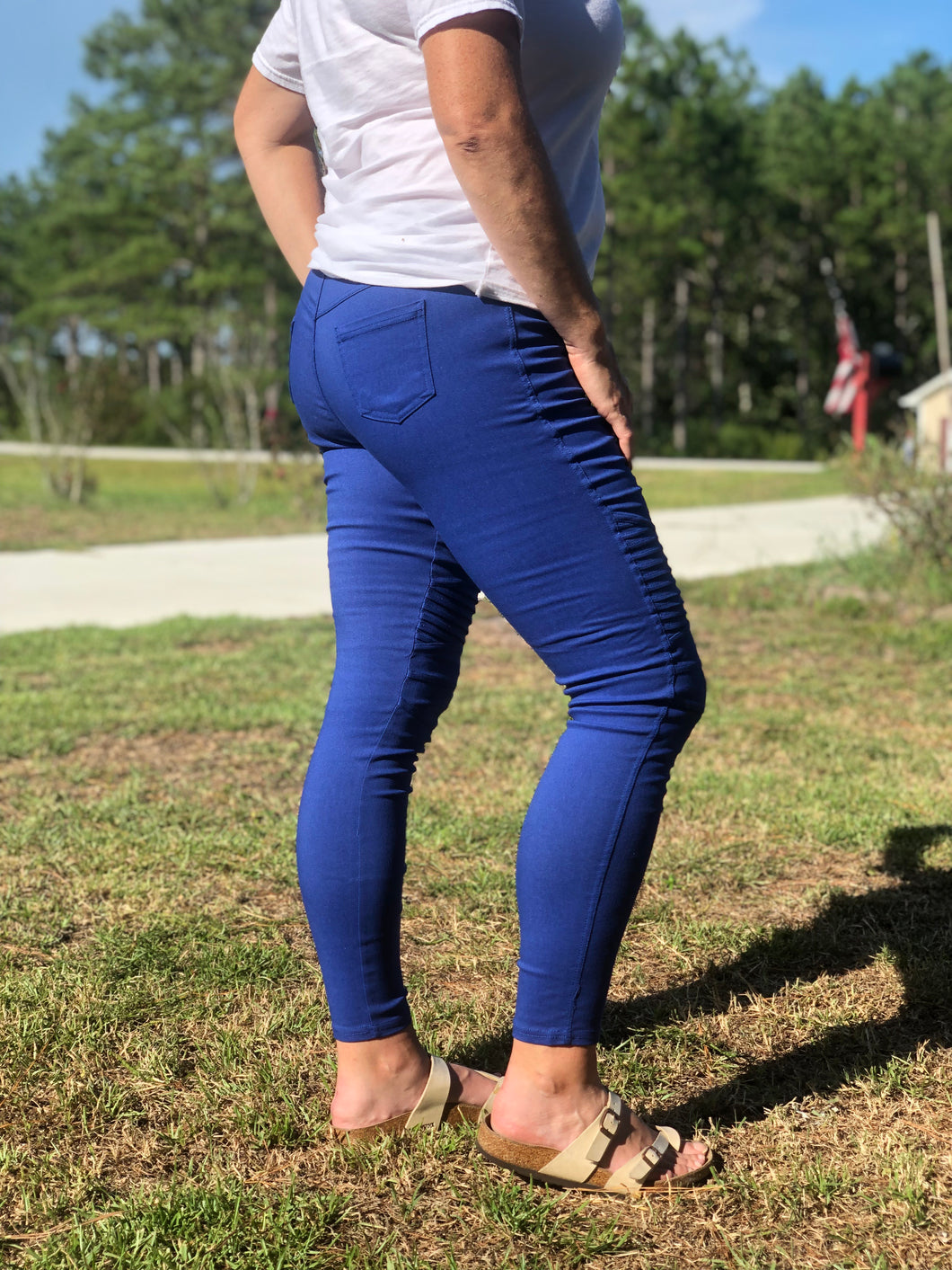 side view of royal blue moto jeggings with real back pockets and an elastic waistband. can be worn everyday casual or with a dressy top and heels. S/M fit- 2-6. M/L fit- 8-10