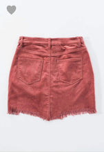 blush pink colored corduroy mini skirt with a zipper fly. equipped with belt loops and pockets. frayed hem on the bottom