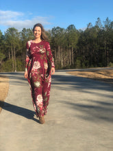 long sleeve burgundy and floral long mazi dress. perfect for short and tall people with its super soft and stretchy material cinched at the small of your waist. beautiful eye catching burgundy color. and has pockets 