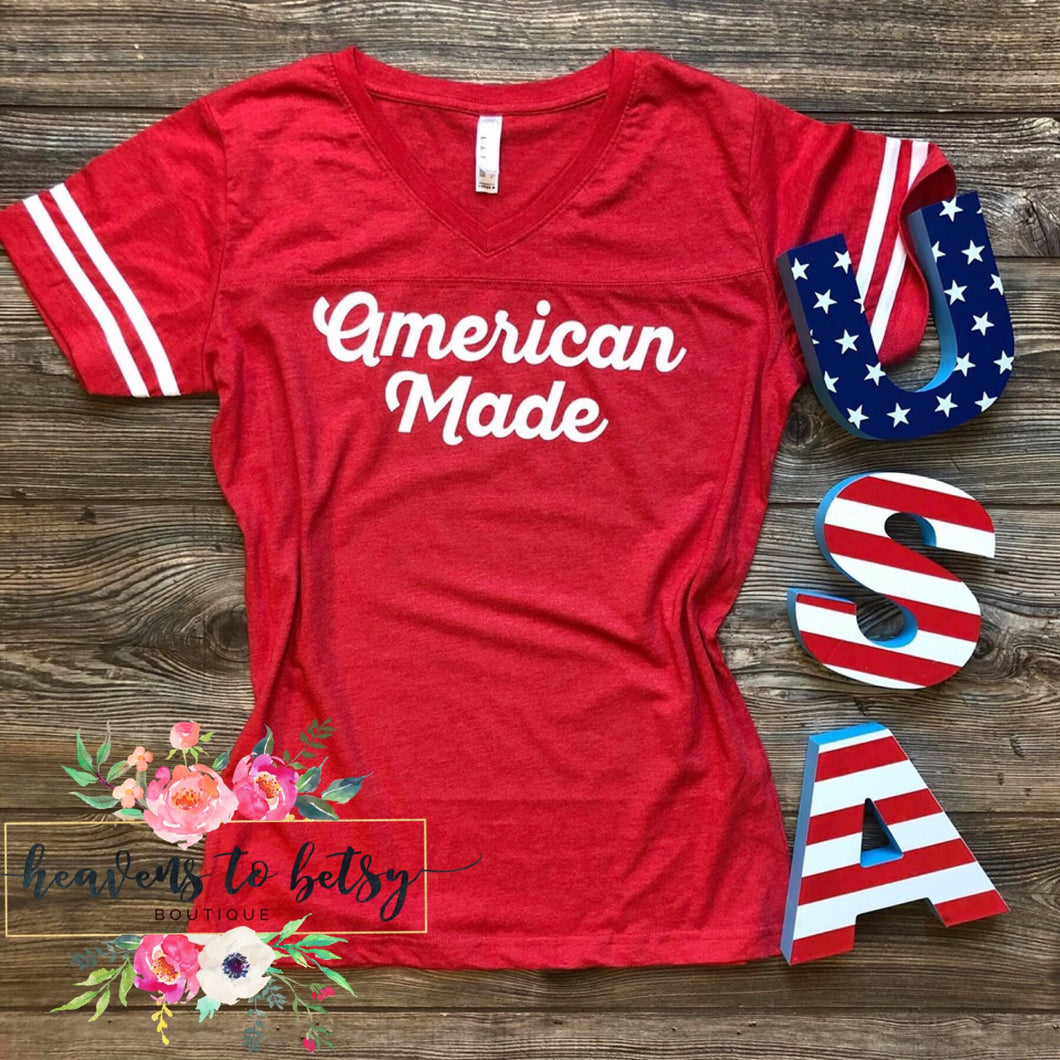 red short sleeve tee with 2 two white strips on sleeves and says american made center in white lettering 