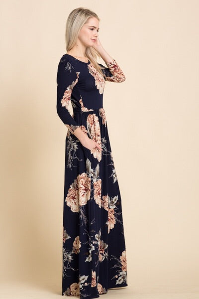 side view of navy and blush floral print long sleeve long maxi dress with cinched waist and pockets