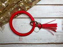 red vibrant red bangle ring keychair with tassle and monogram tag. large ring for any size wrist and easy clip for attaching keys. contains two 2 rings to attach keys to. monochromatic, cute, and fun.