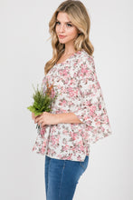 side view of ivory and pink floral pattern 3/4 flyaway sleeves. light weight and flowy