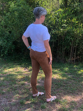 back/ side full body view of camel faux suede moto jeggings with real back pockets and adorable silver zipper accent on front pocket area. jeggings have an elastic waistband and are so soft and comfortable