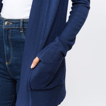 zoomed in view of Navy blue colored soft and cozy cardigan with pockets. long sleeve and in between knee and butt length