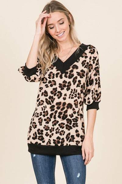 leopard print sweater with thick black trim. V neck and V back with a slouchy and off the shoulder or regular neck.