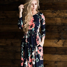 zoomed in view of Navy and coral floral print 3/4 long sleeve long maxi dress with soft and stretchy material, scoopneck, and pockets