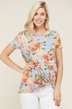 greyish lavender shortsleeve top with floral print and a twist hem at the bottom